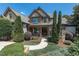 Charming home featuring manicured landscaping and an elegant, arched entryway with double wooden doors at 12317 Richmond Run Dr, Raleigh, NC 27614