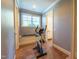Home gym with exercise bike, window for natural light, and adjacent bathroom at 12317 Richmond Run Dr, Raleigh, NC 27614
