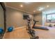 Well-equipped home gym with carpet flooring, treadmill, elliptical, and stationary bike at 12317 Richmond Run Dr, Raleigh, NC 27614