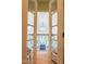 View through glass French doors of hallway with hardwood floors and vaulted ceiling at 12317 Richmond Run Dr, Raleigh, NC 27614