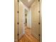 Hallway with hardwood floors, decorative doors, and arched entrance at 12317 Richmond Run Dr, Raleigh, NC 27614