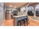 Basement kitchenette features stainless steel appliances, a breakfast bar, and gray cabinets at 12317 Richmond Run Dr, Raleigh, NC 27614