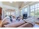 Bright living room features vaulted ceilings, large windows, and a comfortable, oversized leather sectional at 12317 Richmond Run Dr, Raleigh, NC 27614