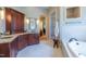Large primary bath with tub, vanity, and shower with white tile at 12317 Richmond Run Dr, Raleigh, NC 27614