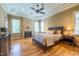 Main bedroom boasts a tray ceiling, fireplace, hardwood floors, and abundant light at 12317 Richmond Run Dr, Raleigh, NC 27614
