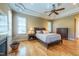 Primary bedroom with tray ceiling, hardwood floors, and lots of natural light at 12317 Richmond Run Dr, Raleigh, NC 27614