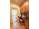 Home office features wood cabinets, built-in desk, and French doors for an open feel at 12317 Richmond Run Dr, Raleigh, NC 27614