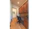 Cozy home office with granite countertop, wooden cabinets, and a comfortable rolling desk chair at 12317 Richmond Run Dr, Raleigh, NC 27614