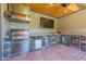 Entertain with this outdoor kitchen, featuring a stone counter, built-in grill, beverage cooler, and a ceiling fan at 12317 Richmond Run Dr, Raleigh, NC 27614