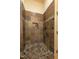 Bathroom features a walk-in shower with earthy-tone tile and dark fixtures for a natural feel at 12317 Richmond Run Dr, Raleigh, NC 27614