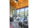 Relaxing screened porch with comfortable wicker seating and views of the surrounding lush landscape at 12317 Richmond Run Dr, Raleigh, NC 27614