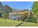 Backyard featuring a covered patio, adorned with plants, creating a cozy outdoor living space at 1315 Brigham Rd, Chapel Hill, NC 27517