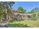 Well-maintained backyard with brick home, wooden deck, patio and lush greenery at 1315 Brigham Rd, Chapel Hill, NC 27517