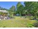 Expansive backyard featuring lush green grass, mature trees, and a charming patio area at 1315 Brigham Rd, Chapel Hill, NC 27517
