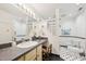 Bright bathroom with an elongated vanity, adjacent toilet, and a walk-in shower at 1315 Brigham Rd, Chapel Hill, NC 27517