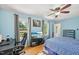 This bedroom is brightly lit and features a ceiling fan, desk, mounted television and comfortable bed at 1315 Brigham Rd, Chapel Hill, NC 27517