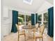 Bright dining area with skylight, patio access, and views of the backyard at 1315 Brigham Rd, Chapel Hill, NC 27517