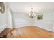 Spacious dining room featuring hardwood floors, elegant chandelier, and ample natural light at 1315 Brigham Rd, Chapel Hill, NC 27517