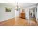 Dining room with hardwood floors, chandelier, and a traditional cabinet at 1315 Brigham Rd, Chapel Hill, NC 27517