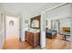 Entryway features hardwood floors, decorative mirror, and a view into the living room at 1315 Brigham Rd, Chapel Hill, NC 27517