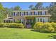 Charming two-story brick home with a well-manicured lawn and mature landscaping at 1315 Brigham Rd, Chapel Hill, NC 27517