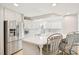 Bright kitchen features white cabinets, stainless steel appliances, and a stylish island with seating at 1315 Brigham Rd, Chapel Hill, NC 27517