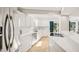 Modern kitchen boasts white cabinetry, stainless appliances, and a view to the outdoor living space at 1315 Brigham Rd, Chapel Hill, NC 27517