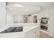 Modern kitchen features white cabinets, stainless steel appliances, and a cooktop on the island at 1315 Brigham Rd, Chapel Hill, NC 27517
