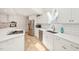 Bright kitchen features white cabinets, stainless steel appliances, and a large sink at 1315 Brigham Rd, Chapel Hill, NC 27517
