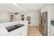 Open kitchen features white cabinets, stainless steel appliances, and a cooktop on the island at 1315 Brigham Rd, Chapel Hill, NC 27517