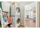 This laundry room features a stacked washer and dryer and wood look floors at 1315 Brigham Rd, Chapel Hill, NC 27517