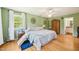 Spacious bedroom with light green walls, white trim, and a large bed with comfortable pillows at 1315 Brigham Rd, Chapel Hill, NC 27517