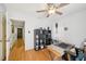 This office is brightly lit and features an ceiling fan, wooden floors, and a metal frame desk at 1315 Brigham Rd, Chapel Hill, NC 27517