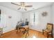 This office is brightly lit and features an ceiling fan, wooden floors, and a metal frame desk at 1315 Brigham Rd, Chapel Hill, NC 27517
