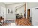 Sitting room with hardwood floors, brick accent wall, and comfortable furniture at 1315 Brigham Rd, Chapel Hill, NC 27517
