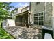 Screened in back porch with brick paver patio leading to the backyard at 140 Sunstone Dr, Cary, NC 27519