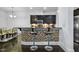 Home bar with tile accents, bar stools, and overhead cabinets, perfect for entertaining at 140 Sunstone Dr, Cary, NC 27519