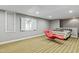 Finished basement featuring unique chaise lounge seating area and striped carpeting at 140 Sunstone Dr, Cary, NC 27519