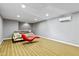 Finished basement features an open layout, unique chaise lounge, and recessed lighting at 140 Sunstone Dr, Cary, NC 27519
