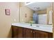Neutral-toned bathroom features wood vanity, white sink, and combination shower and tub at 140 Sunstone Dr, Cary, NC 27519