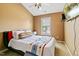 Bedroom featuring a ceiling fan, a large window, and a bed with colorful decorations at 140 Sunstone Dr, Cary, NC 27519