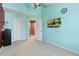 Bedroom with a ceiling fan, a television, neutral carpeting, and light-blue painted walls at 140 Sunstone Dr, Cary, NC 27519