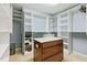 Walk-in closet featuring custom shelving, a center island, and ample storage space at 140 Sunstone Dr, Cary, NC 27519