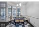 Bright dining room features a glass table, checkerboard rug, and large windows at 140 Sunstone Dr, Cary, NC 27519