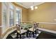 Dining area features a glass table, chairs, a bay window, and stylish checkered rug at 140 Sunstone Dr, Cary, NC 27519