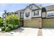 Charming townhome features a two-car garage, stone accents, and well-manicured landscaping at 140 Sunstone Dr, Cary, NC 27519