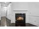 Living room showcasing a fireplace with detailed white trim and dark hardwood flooring at 140 Sunstone Dr, Cary, NC 27519