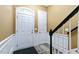 Bright foyer with staircase features white trim, decorative tile, and dark hardwood flooring at 140 Sunstone Dr, Cary, NC 27519