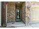 Inviting front entrance with stone facade and glass-paneled door, framed by arched entryway at 140 Sunstone Dr, Cary, NC 27519