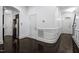 Hallway with stainless steel refrigerator, dark hardwood flooring, and white walls at 140 Sunstone Dr, Cary, NC 27519
